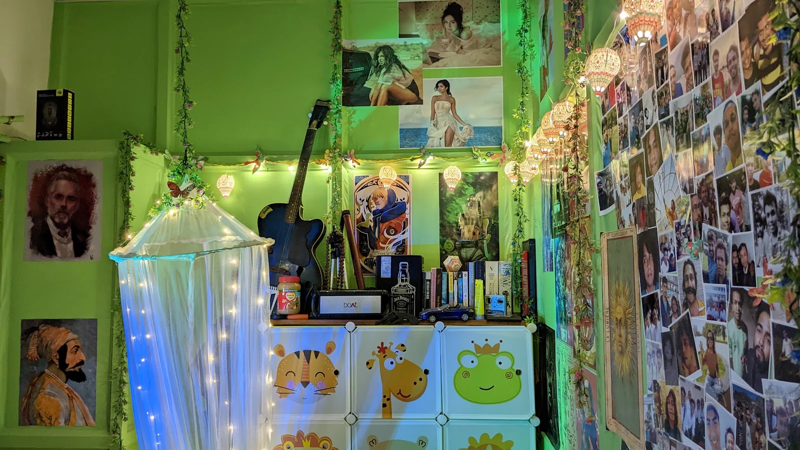 Green room scene with an acoustic guitar, bookshelves, hanging paper lanterns, and a wall of photographs.
